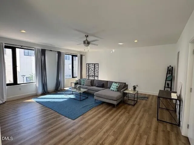 a living room with furniture and wooden floor