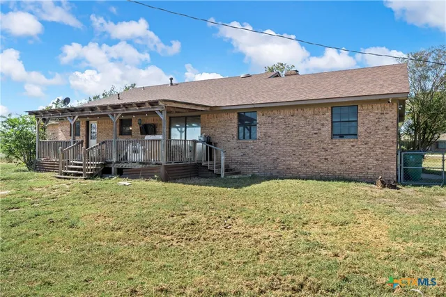 a view of a house with wooden fence