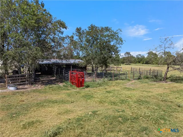 a view of field with trees in background