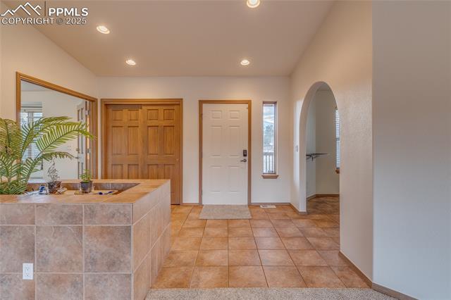 From family room looking toward front door entry - primary bedroom to the left and dining room to the right. 