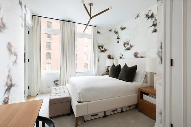 a bedroom with a bed and a chandelier