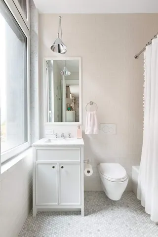 a bathroom with a granite countertop sink a toilet and a mirror