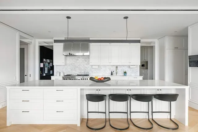 a kitchen with stainless steel appliances kitchen island granite countertop a table and chairs in it