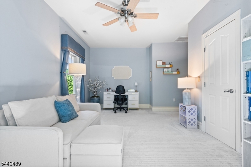 99 East Lindsley Road Cedar Grove, NJ 07009 - Photo 33 of 41 a living room with furniture and a chandelier