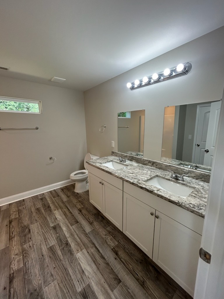 708 Hampton Street Iva, SC 29655 - Photo 9 of 14 This spacious bathroom features a double vanity and sleek flooring, offering comfort and style.