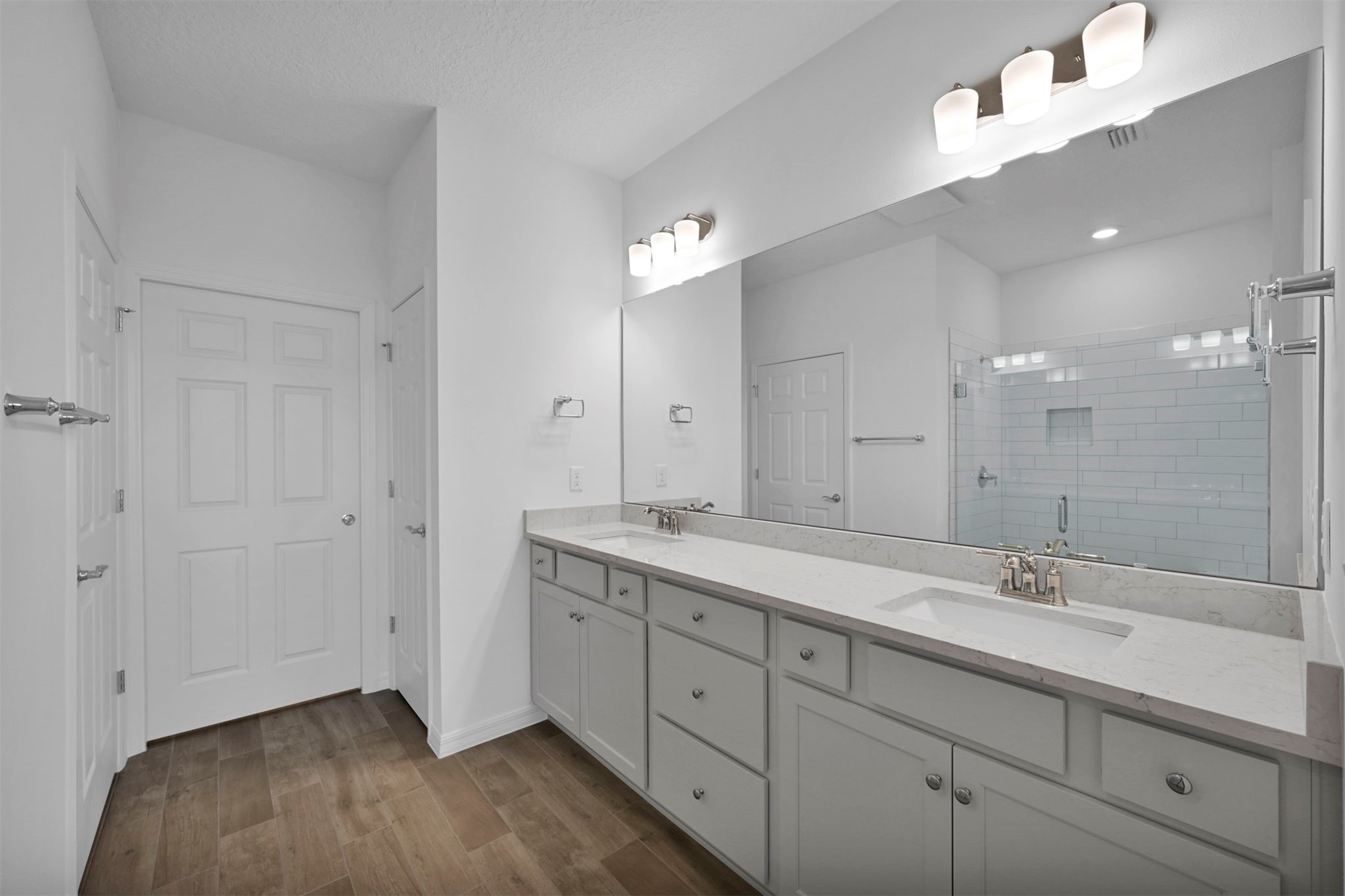 285 Ecliptic Loop Yulee, FL 32097 - Photo 19 of 42 a spacious bathroom with a granite countertop double vanity sink a mirror and a