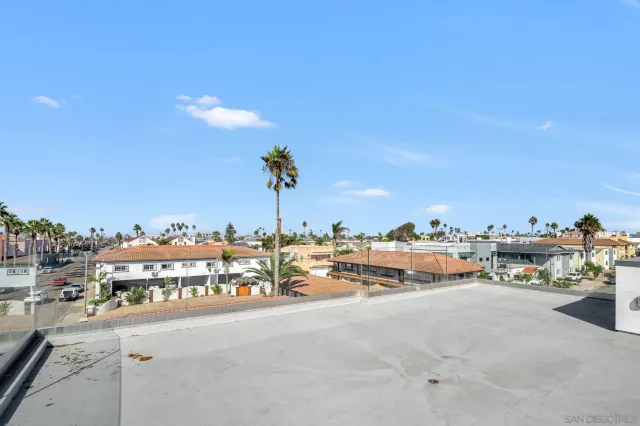 a bathroom with a granite countertop sink two mirror and shower