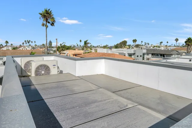 a bathroom with a tub a mirror and a shower