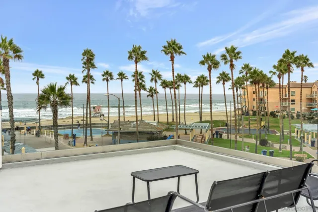 a terrace with a bench and chairs