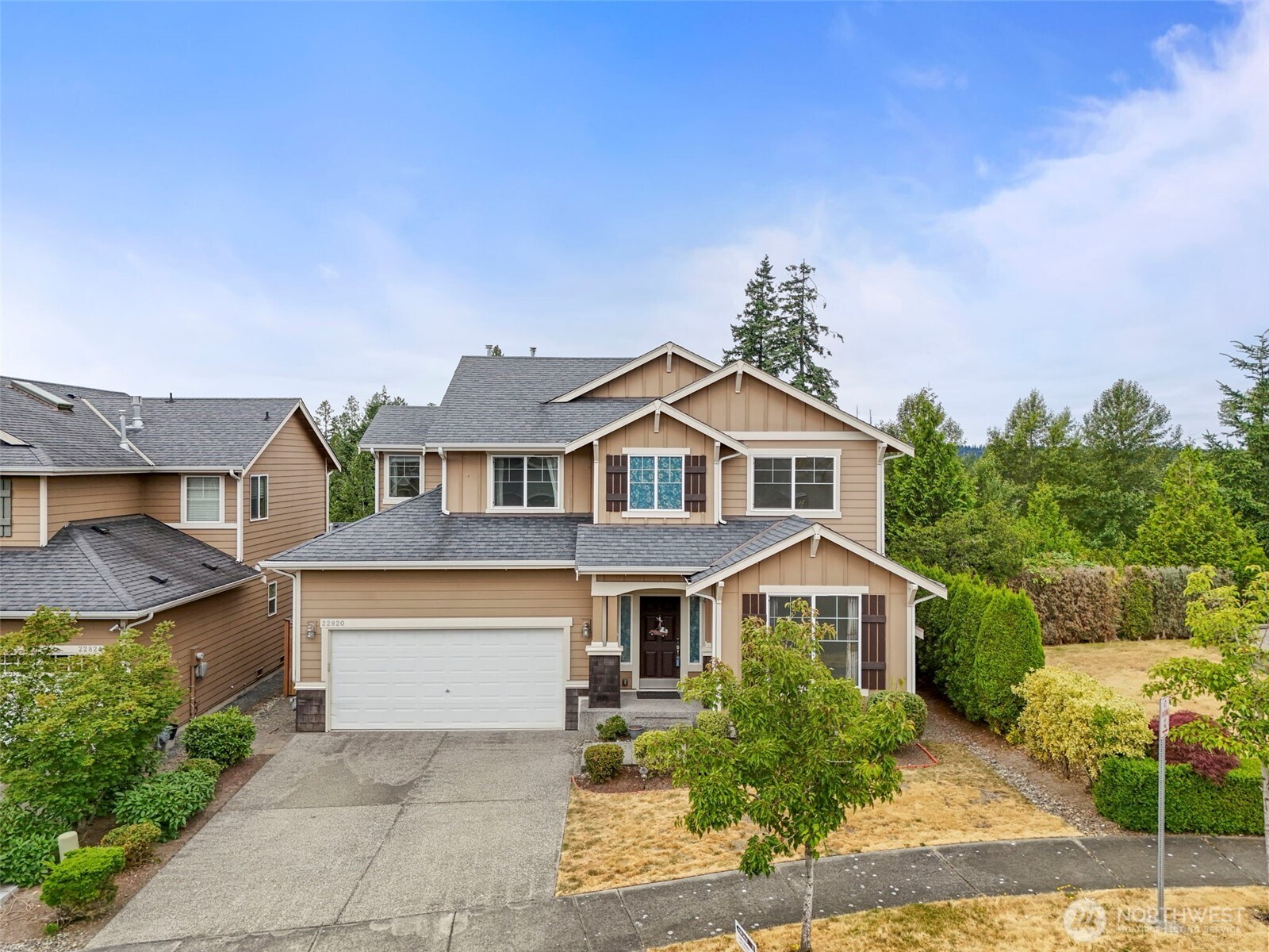 22820 41st Drive Southeast Bothell, WA 98021 - Photo 3 of 38 a front view of a house with a yard and garage