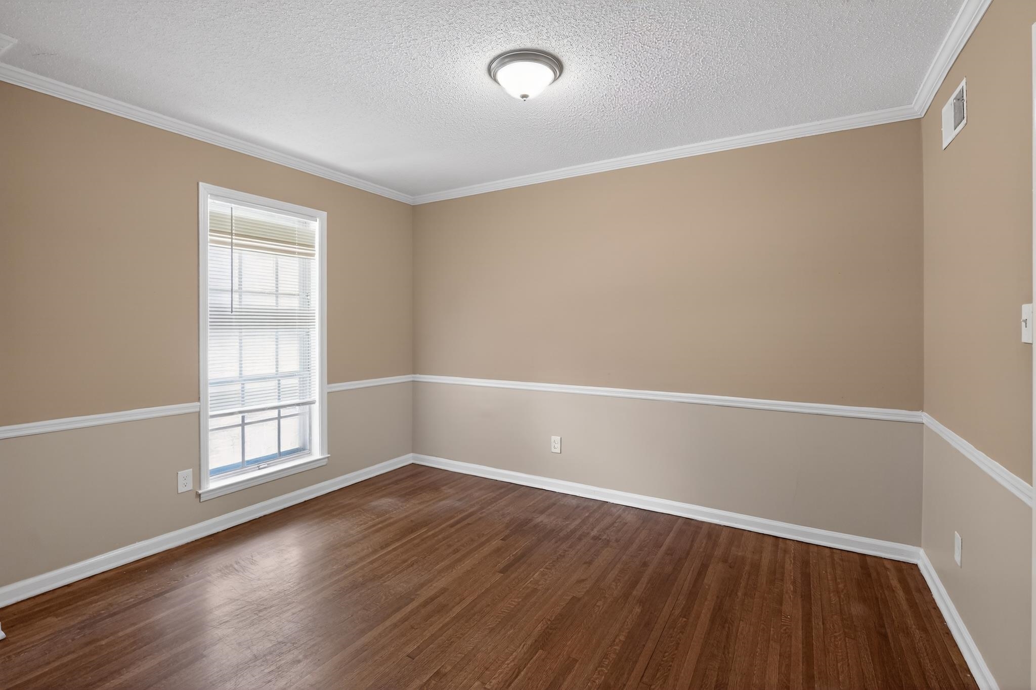 2015 East Holmes Road Memphis, TN 38116 - Photo 14 of 34 an empty room with wooden floor and windows