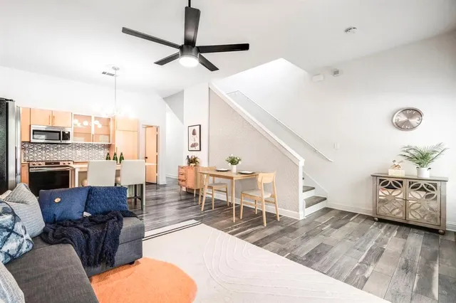 a living room with furniture and a wooden floor
