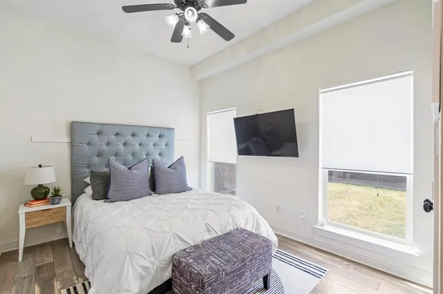 a bedroom with a large bed and a tv