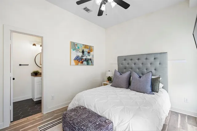 a bedroom with a bed and a chandelier