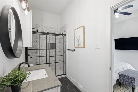 a bathroom with a sink toilet and shower
