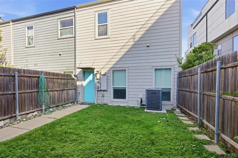 a view of a backyard with wooden fence