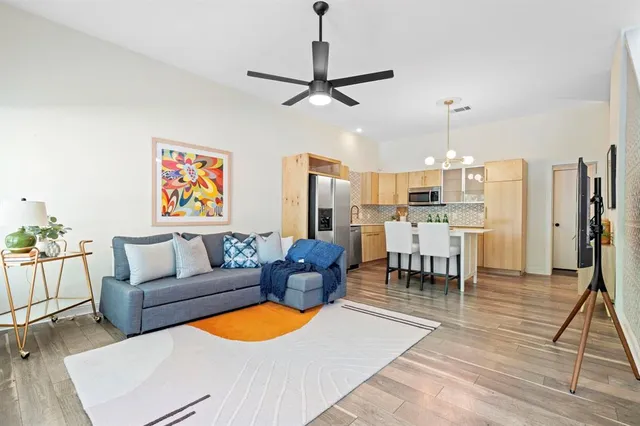 a living room with furniture and kitchen view