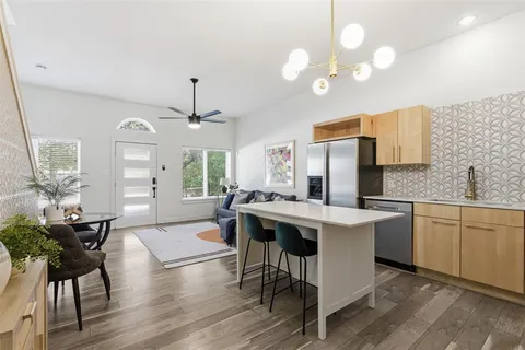 a kitchen that has a table and chairs in it