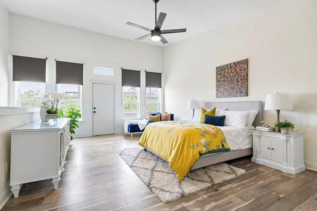 a spacious bedroom with a bed and a chandelier
