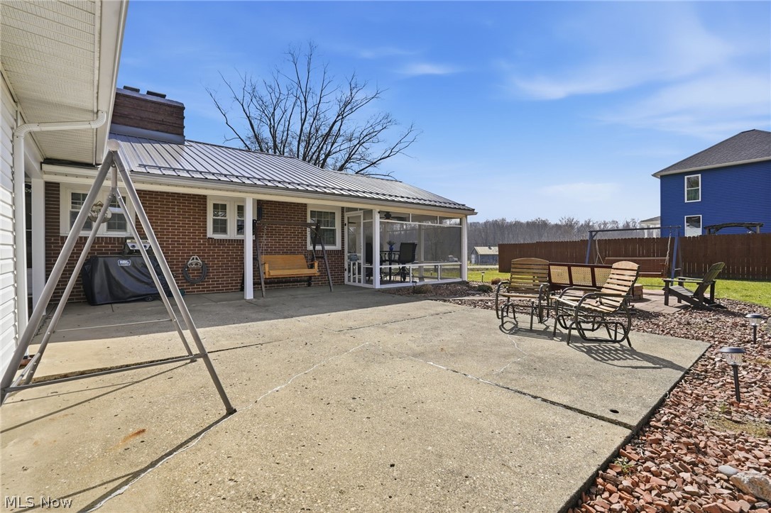 6655 Ceramic Road Crooksville, OH 43731 - Photo 3 of 34 View of patio / terrace with a grill and a sunroom