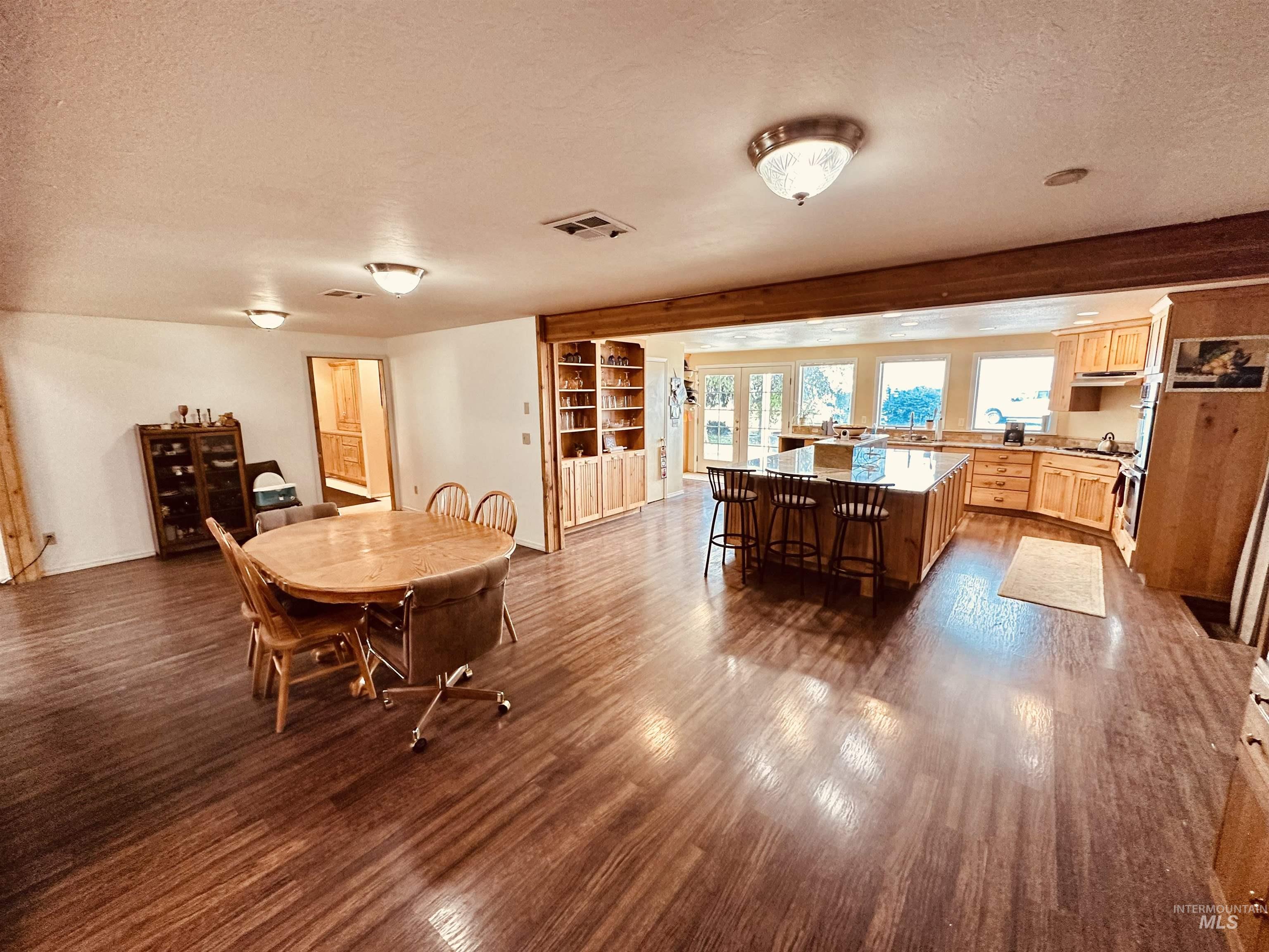 1049 Grand Avenue Nyssa, OR 97913 - Photo 12 of 50 Spacious open-concept interior featuring wood-finish flooring throughout