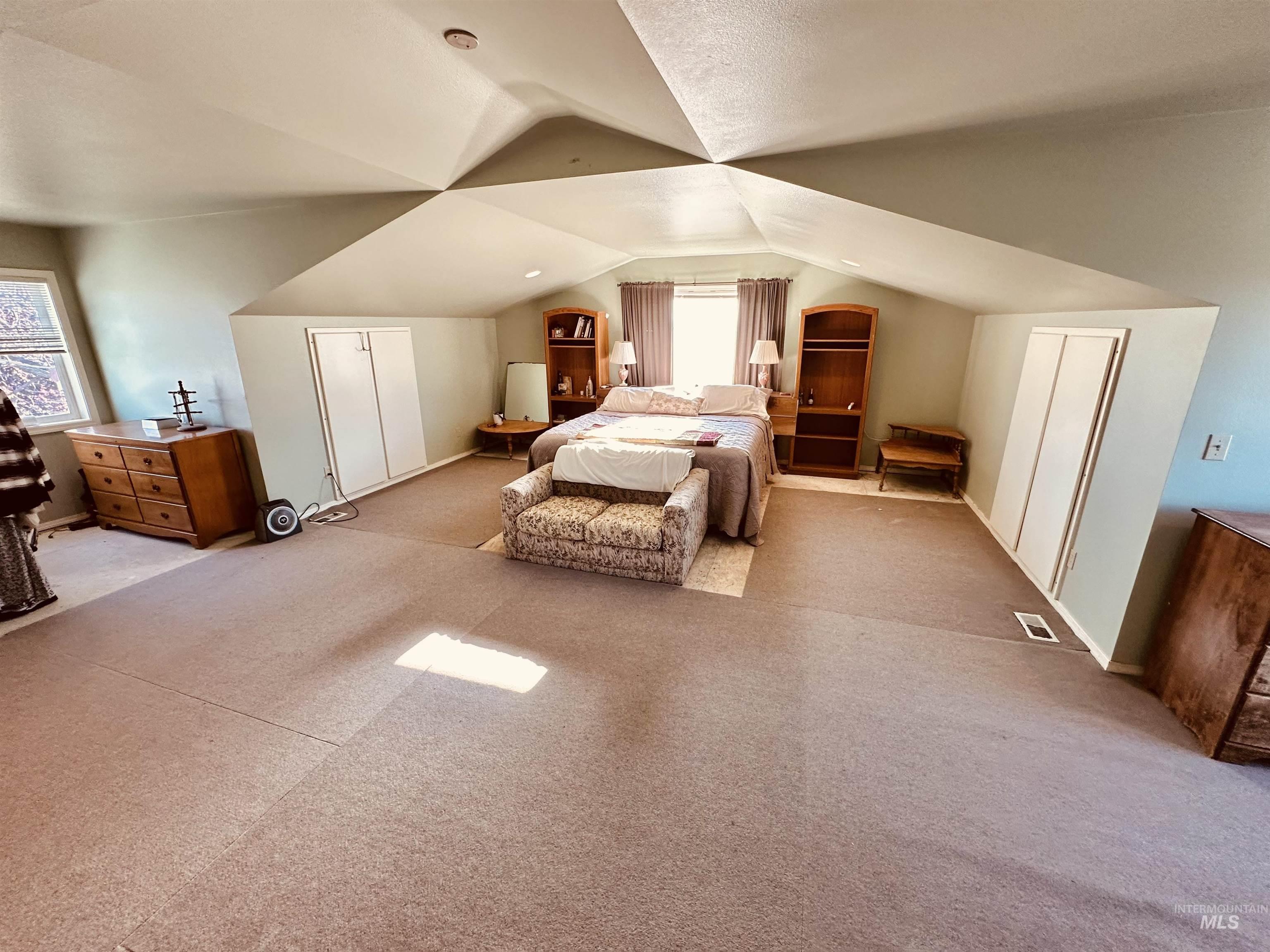 1049 Grand Avenue Nyssa, OR 97913 - Photo 17 of 50 Vaulted ceiling room featuring light-colored walls and carpeted flooring