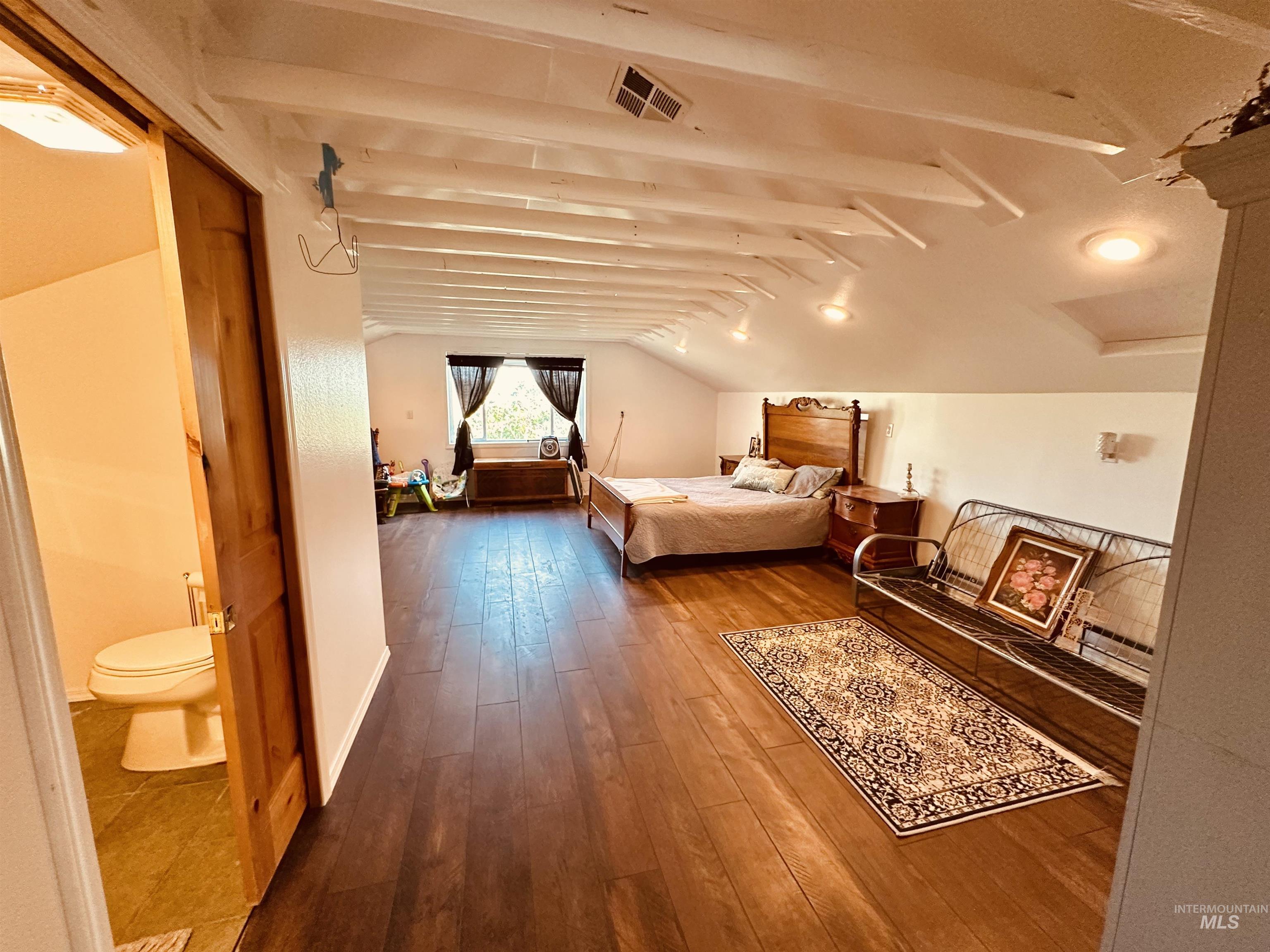 1049 Grand Avenue Nyssa, OR 97913 - Photo 20 of 50 Spacious room with dark wood-finish flooring and an exposed beam ceiling