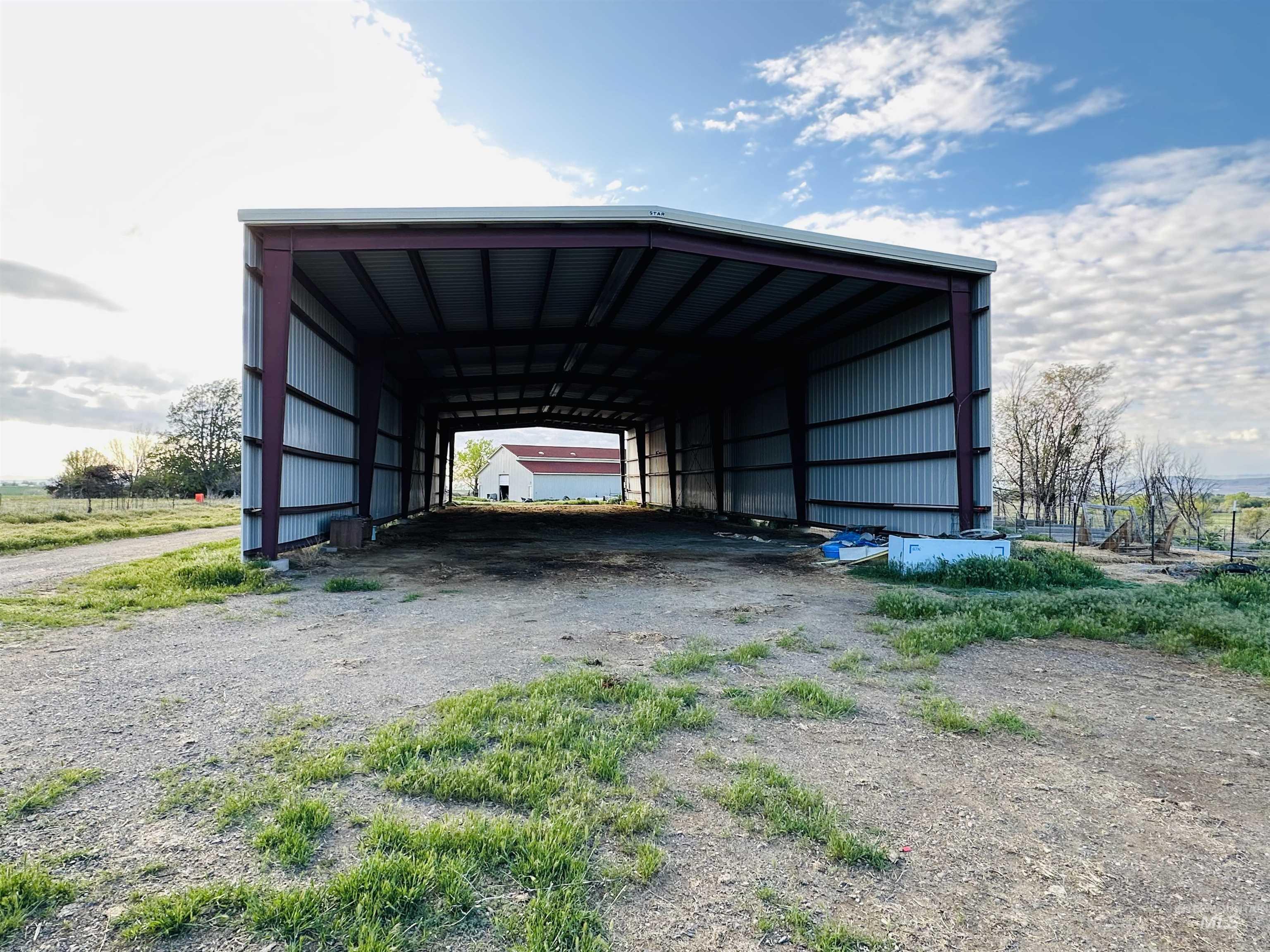 1049 Grand Avenue Nyssa, OR 97913 - Photo 35 of 50 Spacious metal-frame shelter with an open-sided design, corrugated metal roofing, and corrugated metal siding 50 X 150 hay barn