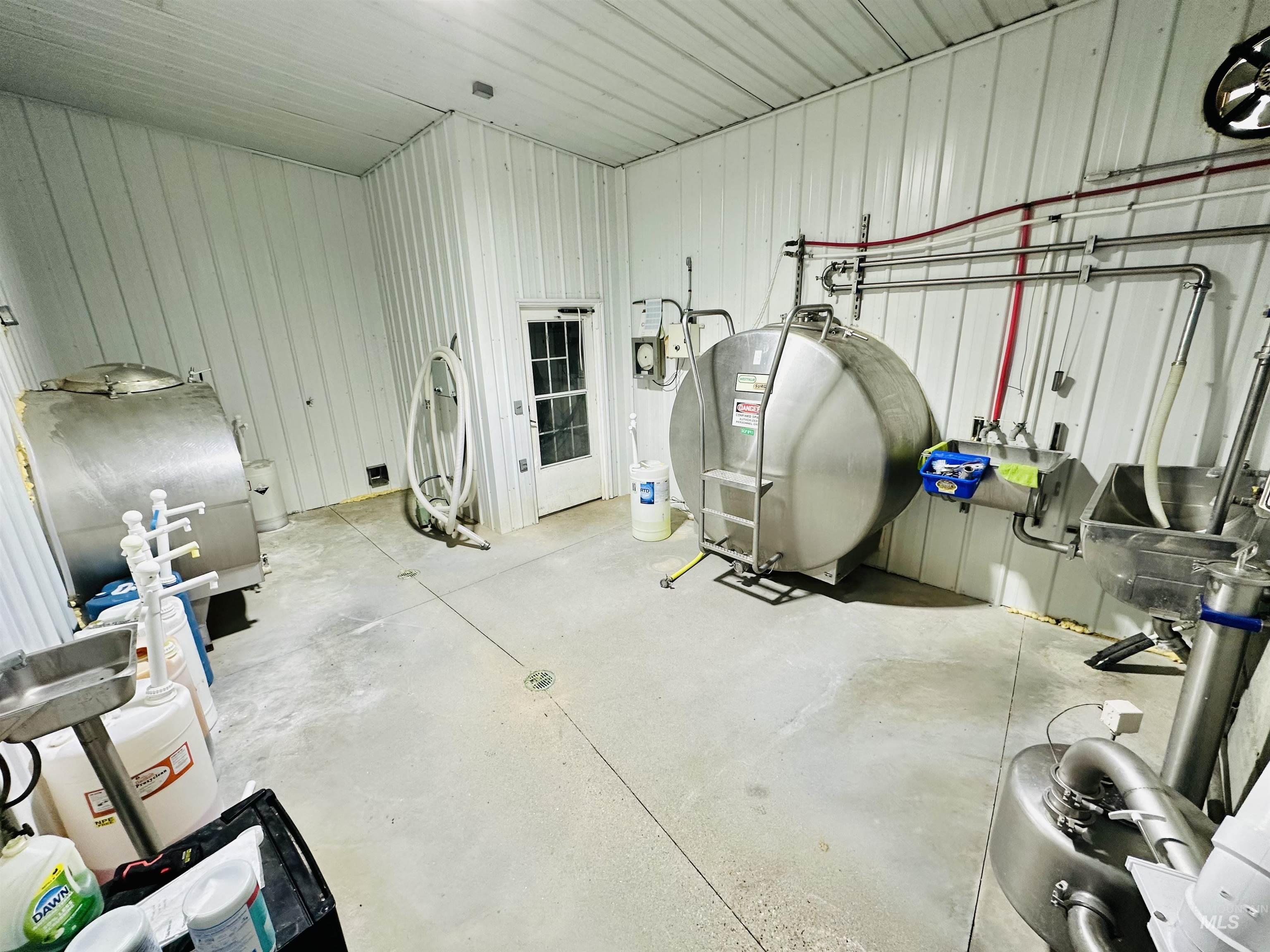 1049 Grand Avenue Nyssa, OR 97913 - Photo 38 of 50 Industrial interior featuring corrugated panel walls, concrete flooring, and stainless steel tanks