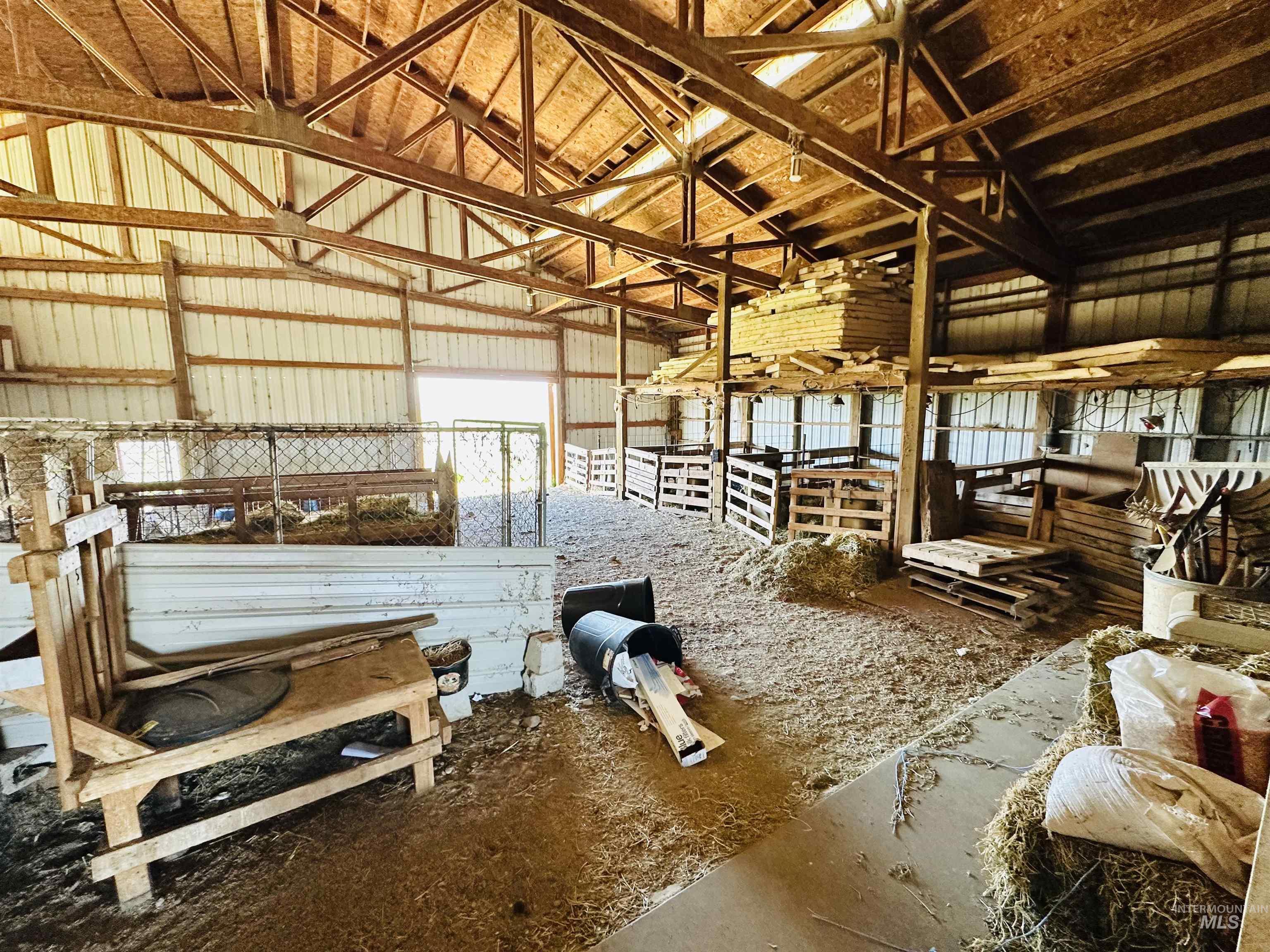 1049 Grand Avenue Nyssa, OR 97913 - Photo 41 of 50 Open-span barn interior featuring exposed wood rafters and corrugated metal walls