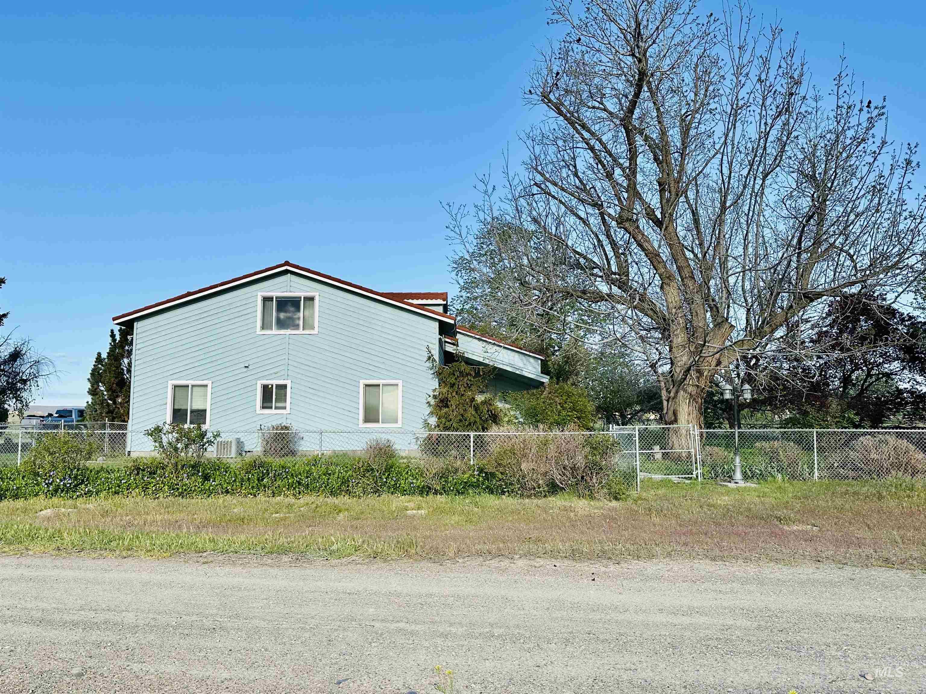 1049 Grand Avenue Nyssa, OR 97913 - Photo 45 of 50 Two-story property featuring light blue siding and a brown-trimmed gable roof