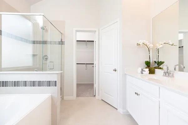 a bathroom with a tub sink and mirror
