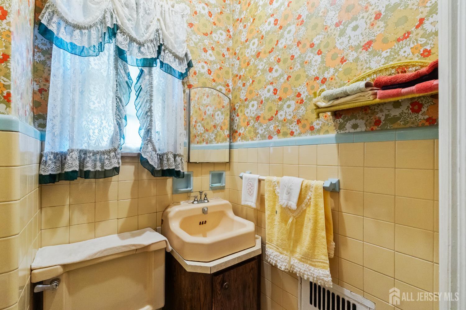 72 Bailey Avenue Hillside, NJ 07205 - Photo 20 of 20 a bathroom with a sink and a shower curtain