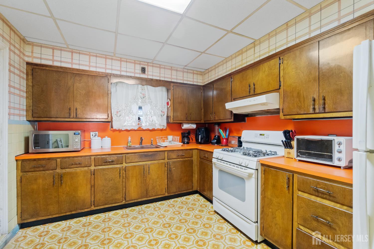 72 Bailey Avenue Hillside, NJ 07205 - Photo 4 of 20 a kitchen with stainless steel appliances granite countertop a sink and cabinets