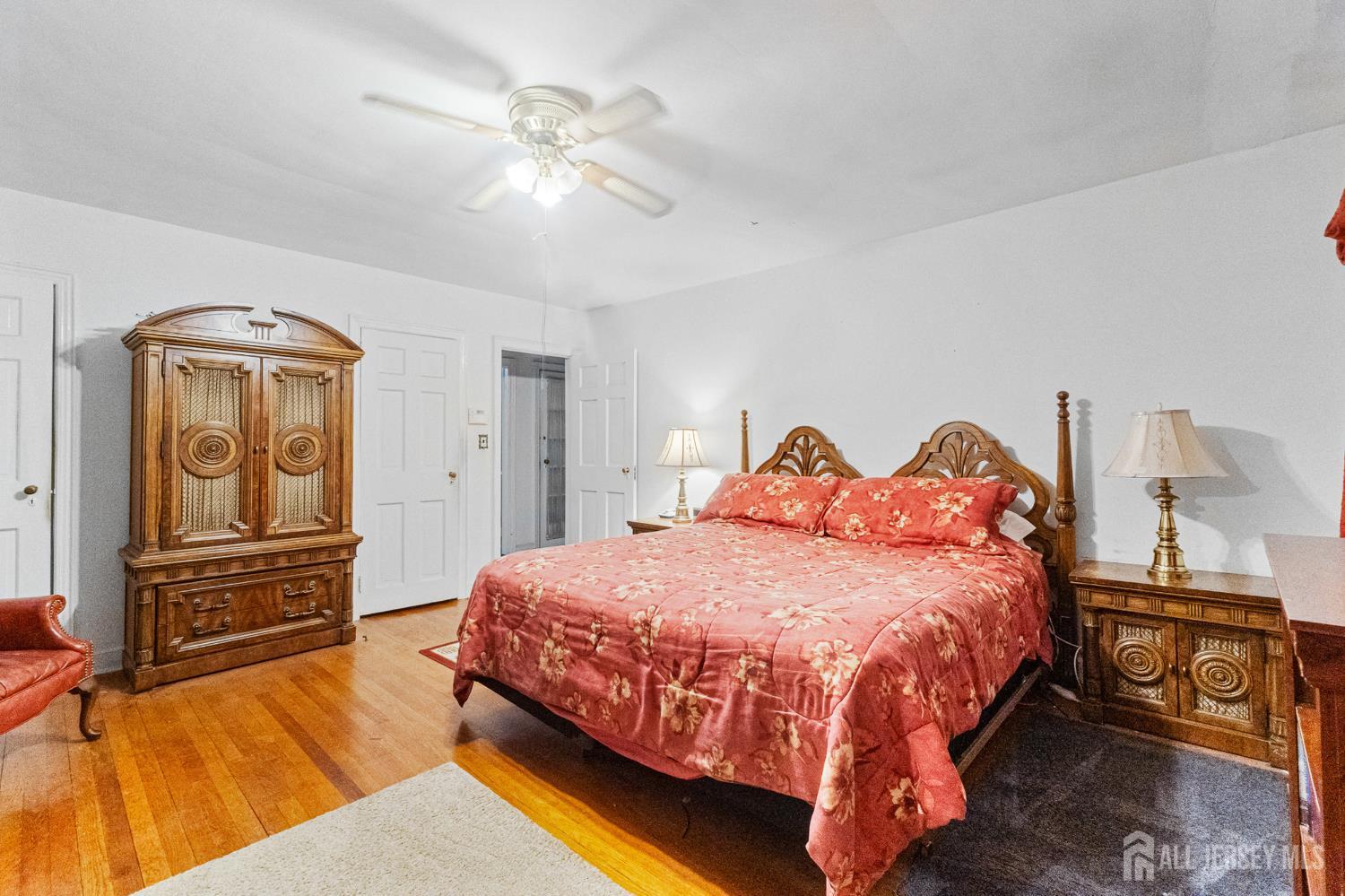 72 Bailey Avenue Hillside, NJ 07205 - Photo 7 of 20 a bedroom with a bed and a chandelier