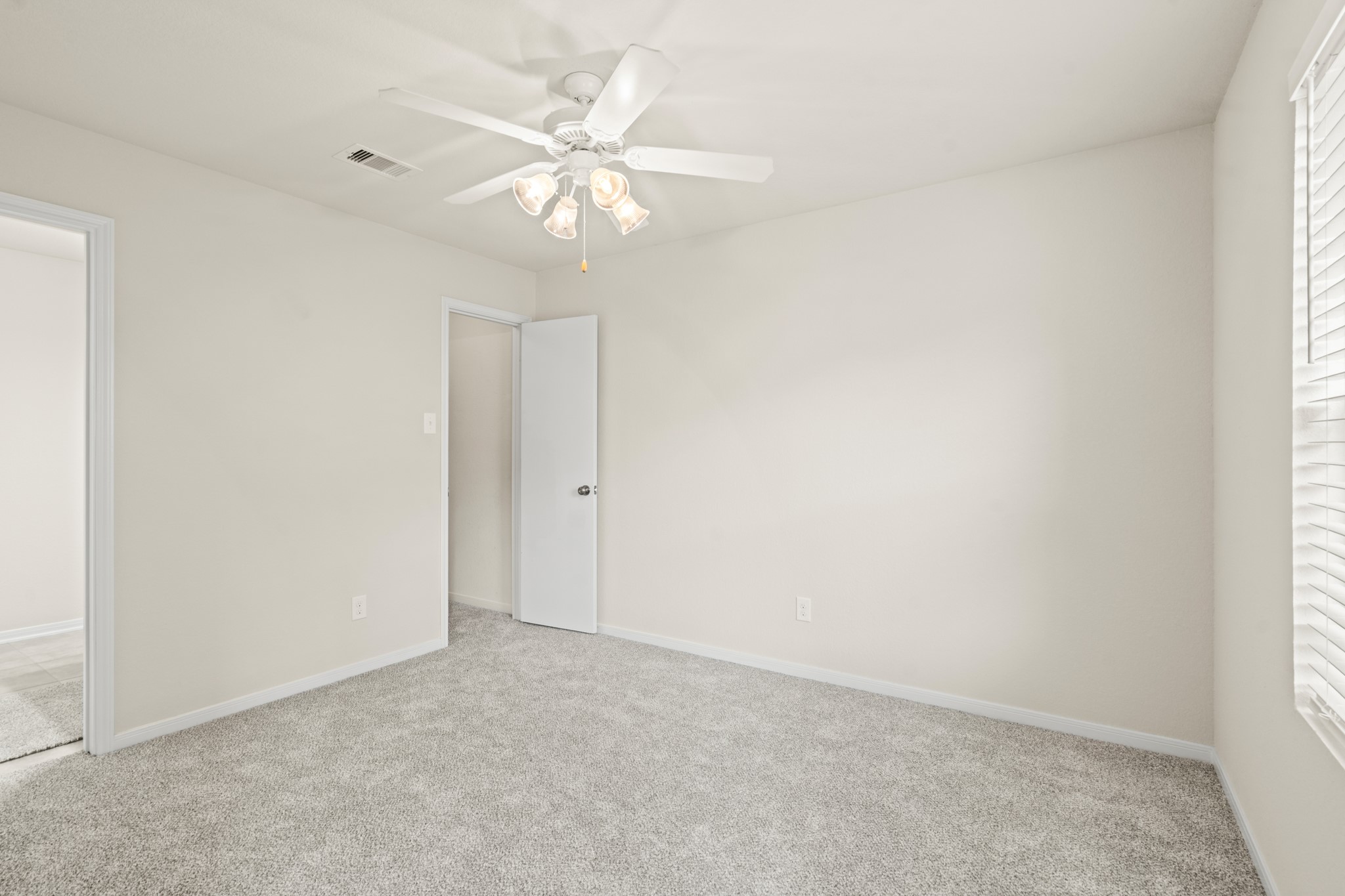 3118 Winchester Rnch Trail Katy, TX 77493 - Photo 11 of 36 an empty room with a chandelier fan