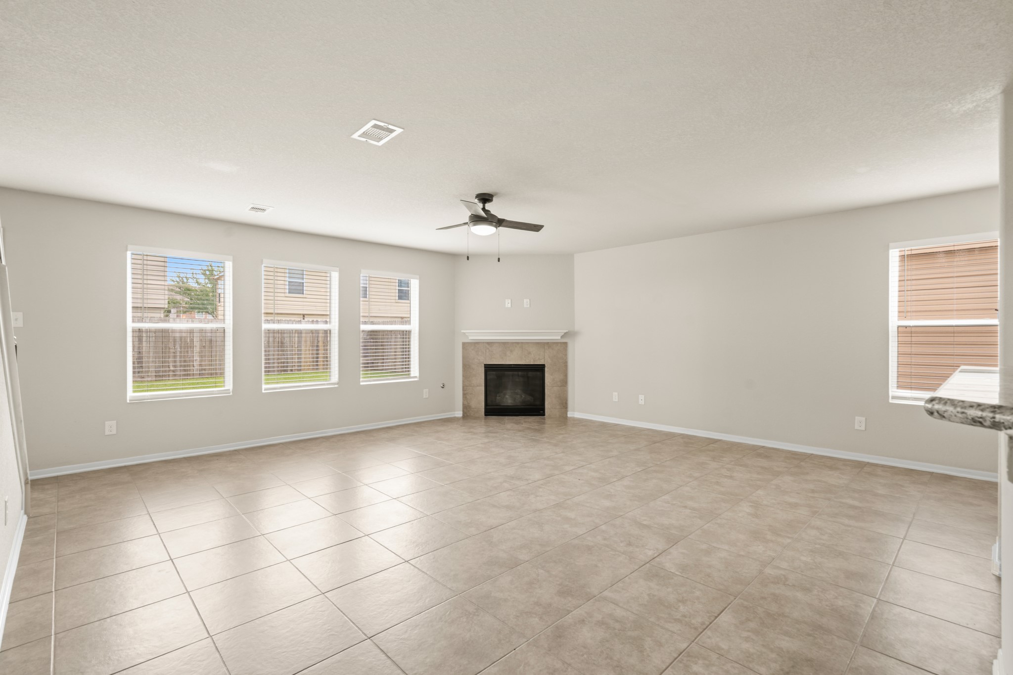 3118 Winchester Rnch Trail Katy, TX 77493 - Photo 14 of 36 an empty room with windows and fireplace