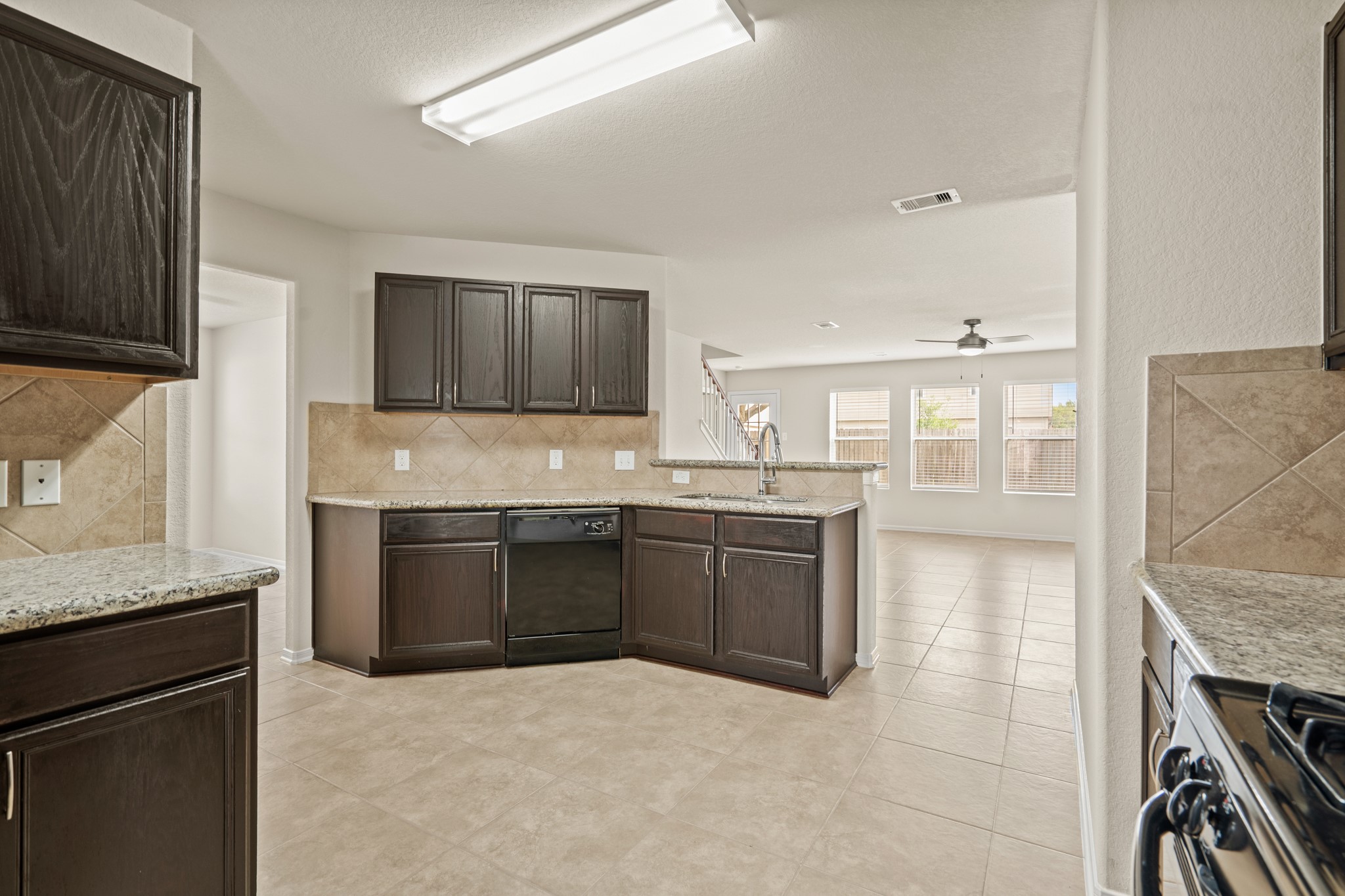 3118 Winchester Rnch Trail Katy, TX 77493 - Photo 20 of 36 a kitchen with granite countertop a stove top oven sink and cabinets