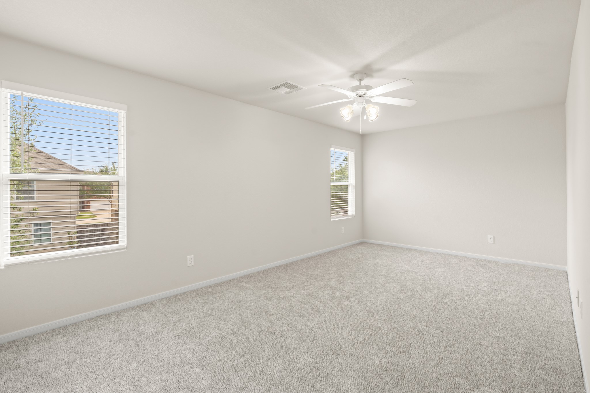 3118 Winchester Rnch Trail Katy, TX 77493 - Photo 23 of 36 an empty room with windows and fan