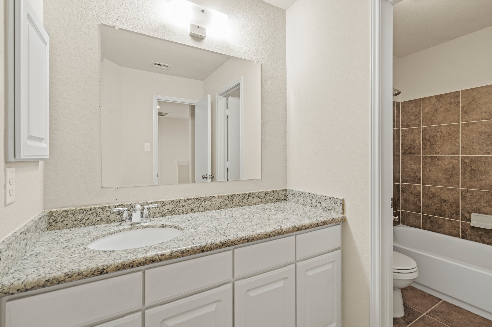 3118 Winchester Rnch Trail Katy, TX 77493 - Photo 34 of 36 a bathroom with a granite countertop sink and mirror with bathtub