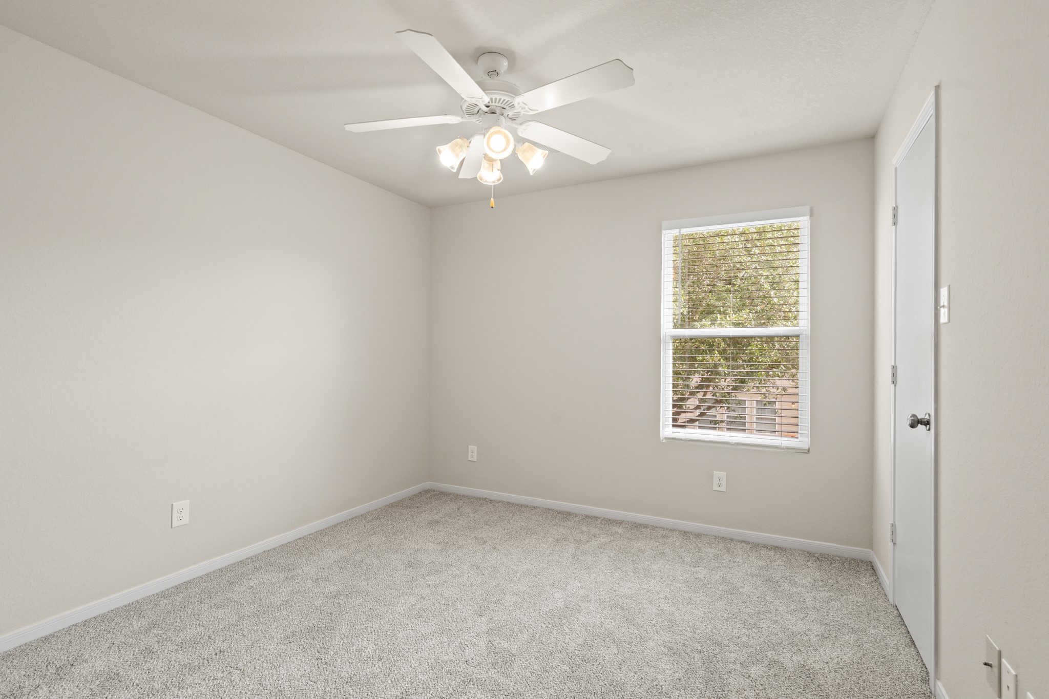 3118 Winchester Rnch Trail Katy, TX 77493 - Photo 36 of 36 an empty room with windows and chandelier fan