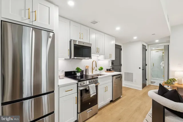 a kitchen with stainless steel appliances a refrigerator stove microwave and sink