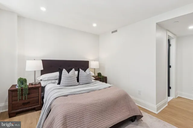 a bedroom with a bed and a lamp