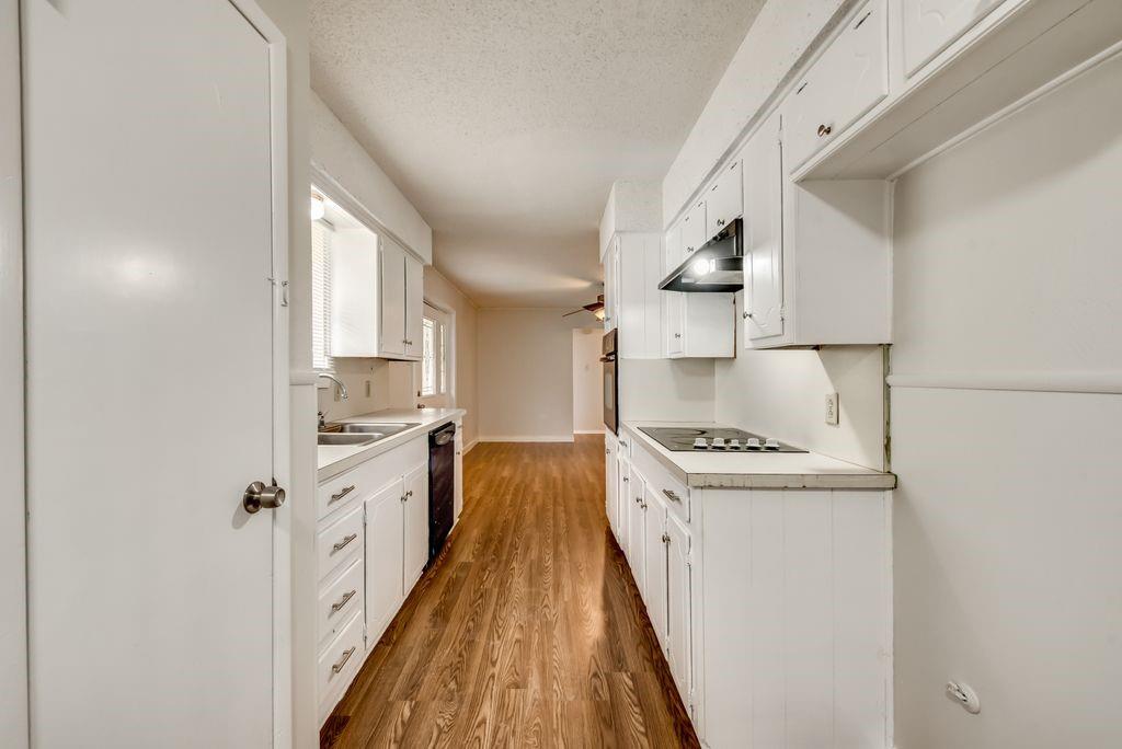 a kitchen with white cabinets and white appliances