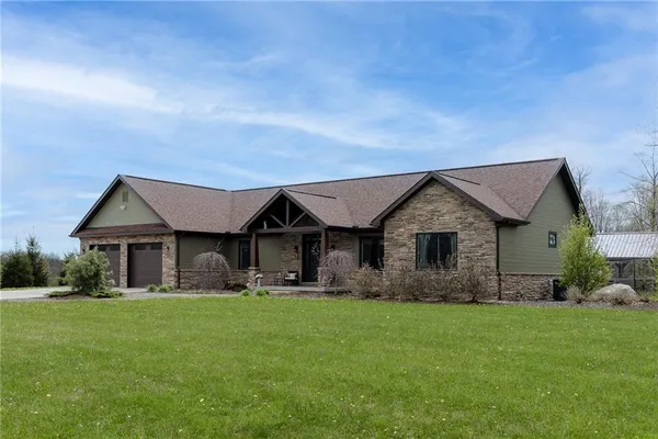 a front view of house with yard and green space