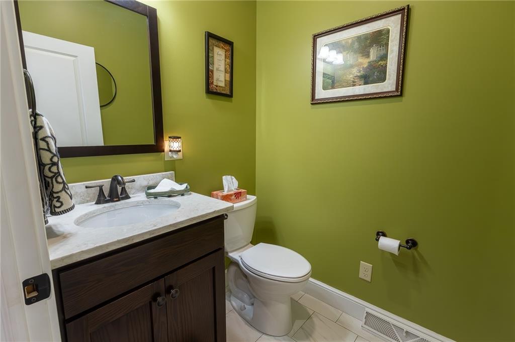 130 Parker Road Mercer, PA 16137 - Photo 20 of 50 a bathroom with a granite countertop toilet sink and mirror