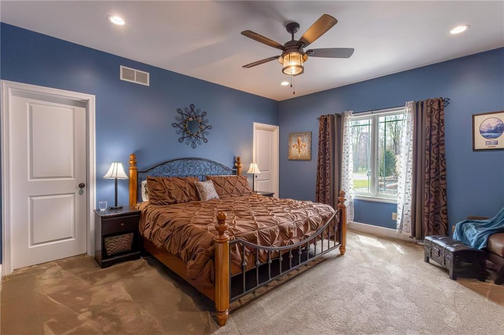 130 Parker Road Mercer, PA 16137 - Photo 23 of 50 a bedroom with a bed and a chandelier
