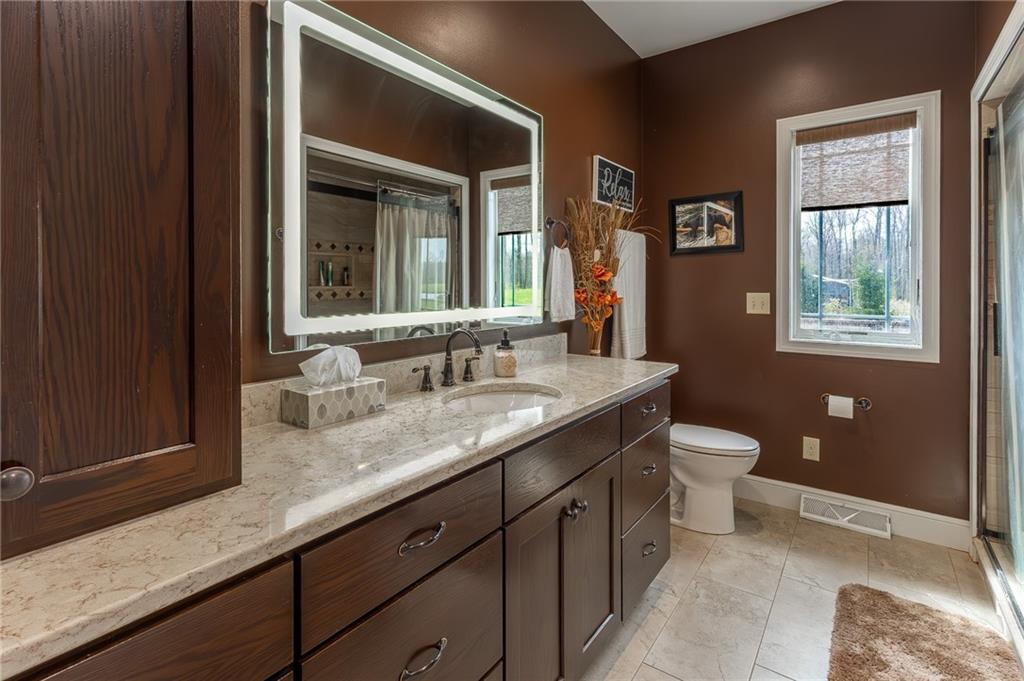 130 Parker Road Mercer, PA 16137 - Photo 26 of 50 a bathroom with a granite countertop sink toilet and mirror