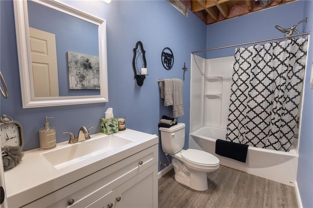 130 Parker Road Mercer, PA 16137 - Photo 32 of 50 a bathroom with a toilet a sink and a large mirror