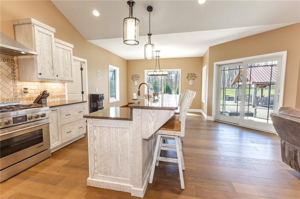 130 Parker Road Mercer, PA 16137 - Photo 4 of 50 a kitchen with stainless steel appliances kitchen island wooden floors and white cabinets